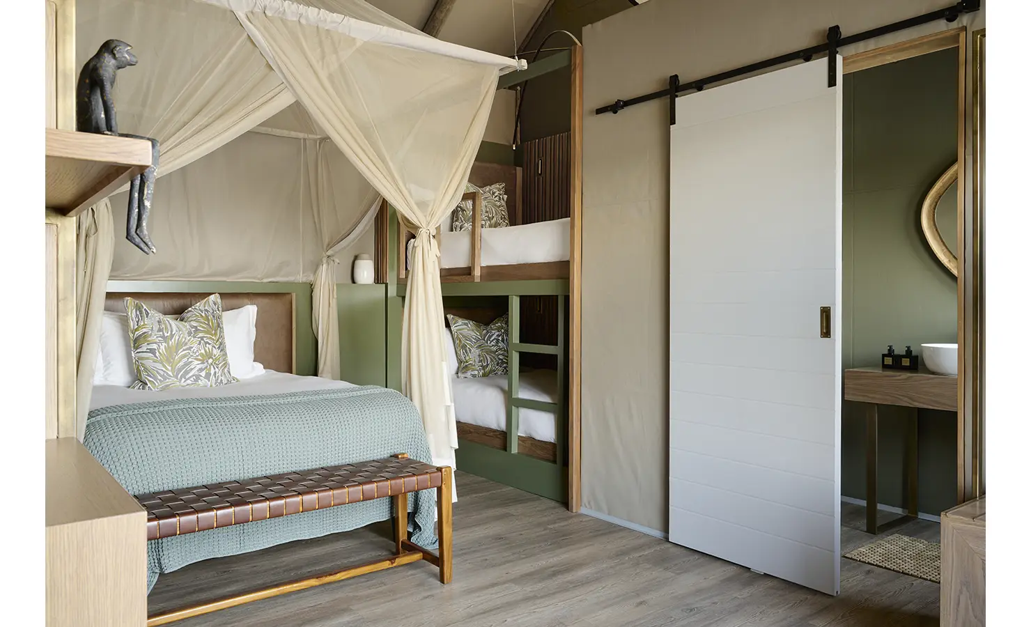 Perfect Hideaways: Family room with curtained four-poster, built-in bunk beds and a sliding barn door to the bathroom, Rapid's View Villa, Zambezi National Park