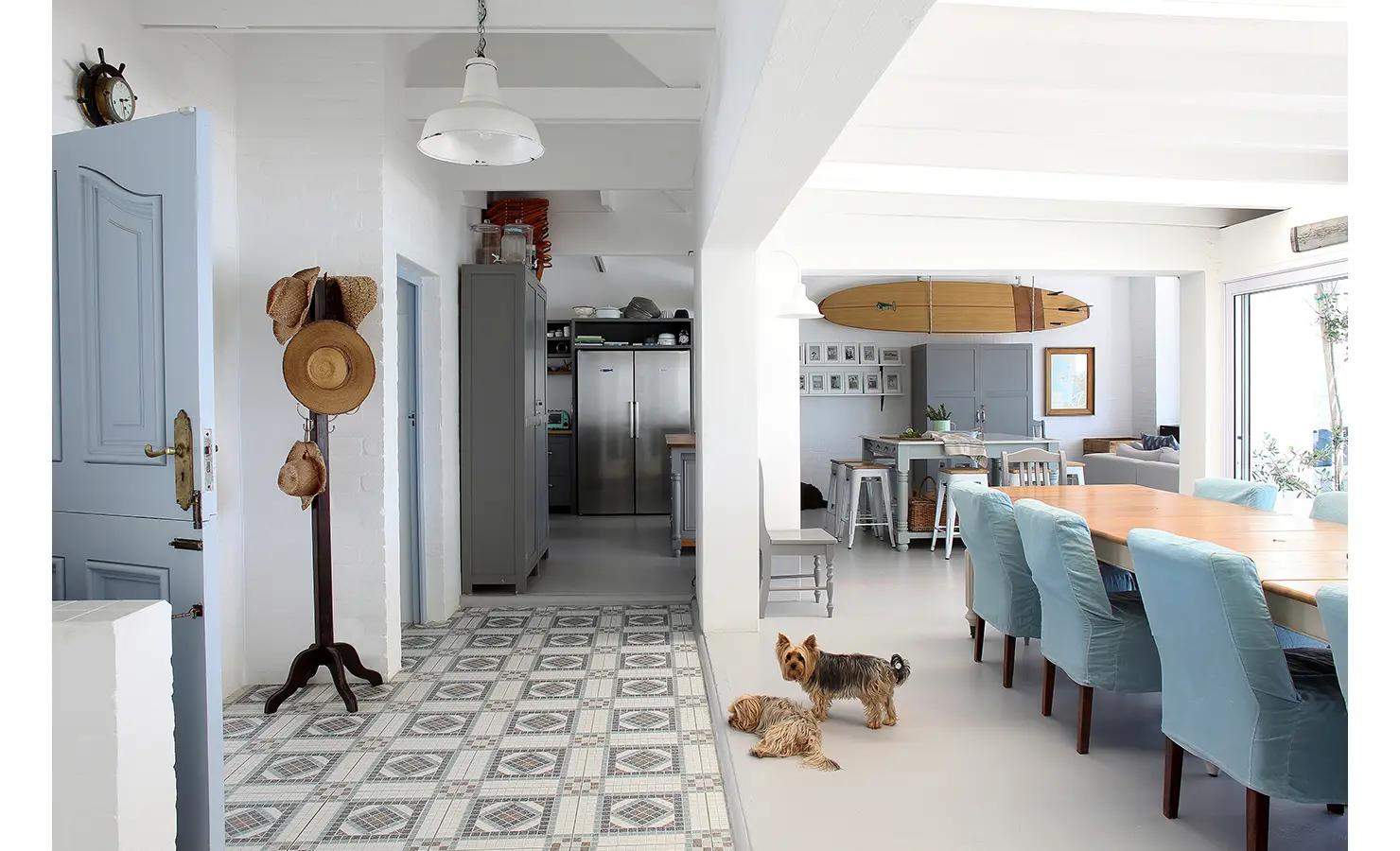 Perfect Hideaways: coastal hallway with patterned tiles, a stand of straw hats and two small dogs leading to the open-plan kitchen and dining area, Langebaan, Lagoon Lookout.