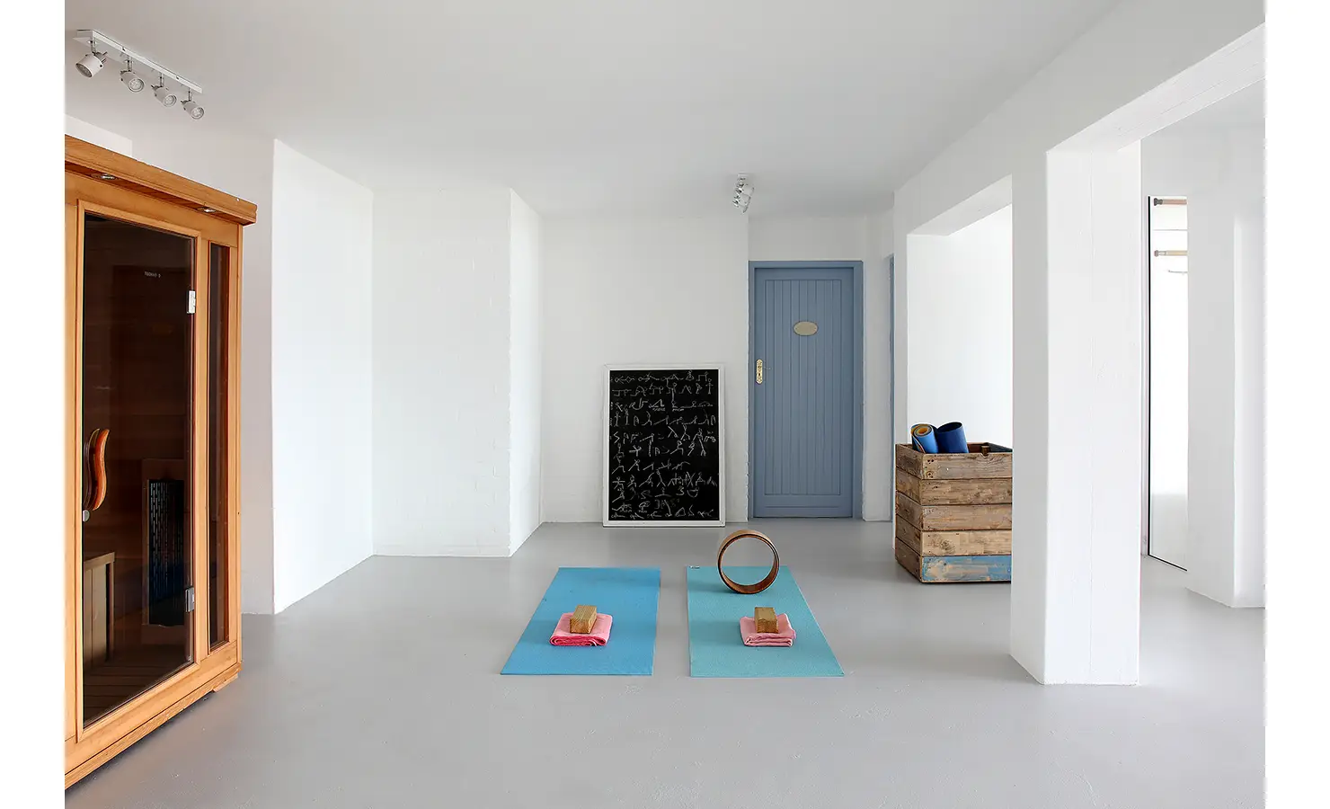 Perfect Hideaways: minimalist wellness room with sauna, blue door and yoga mats laid out for practice, Langebaan, Lagoon Lookout.