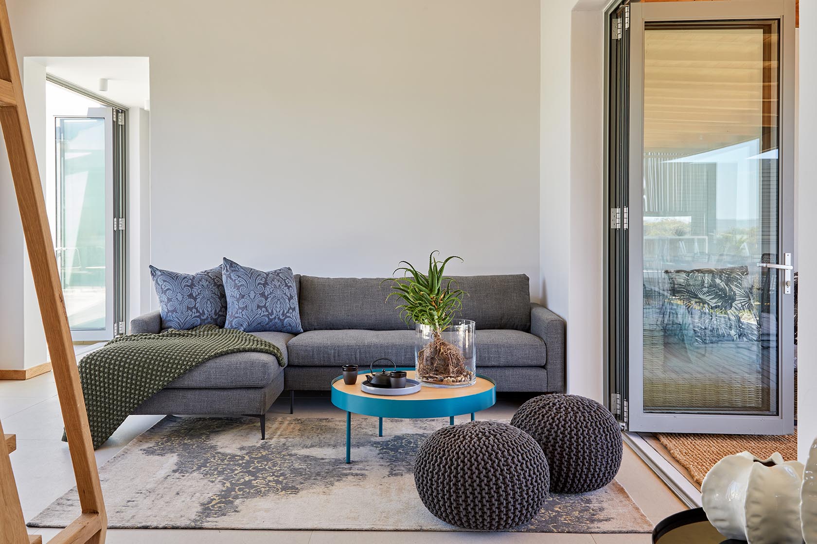 Perfect Hideaways cosy living room with grey sofa, textured rug, woven poufs and indoor plant, Kalie's Cottage, Churchhaven