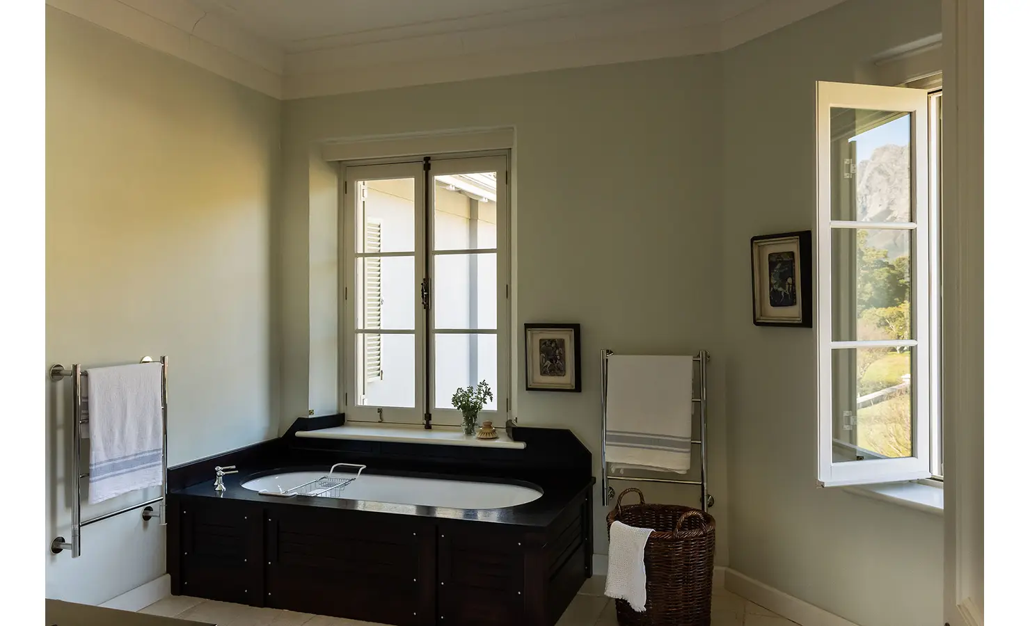 Perfect Hideaways elegant bathroom with a dark wood bathtub, open windows, and natural light illuminating soft green walls, Franschhoek, Varuna.
