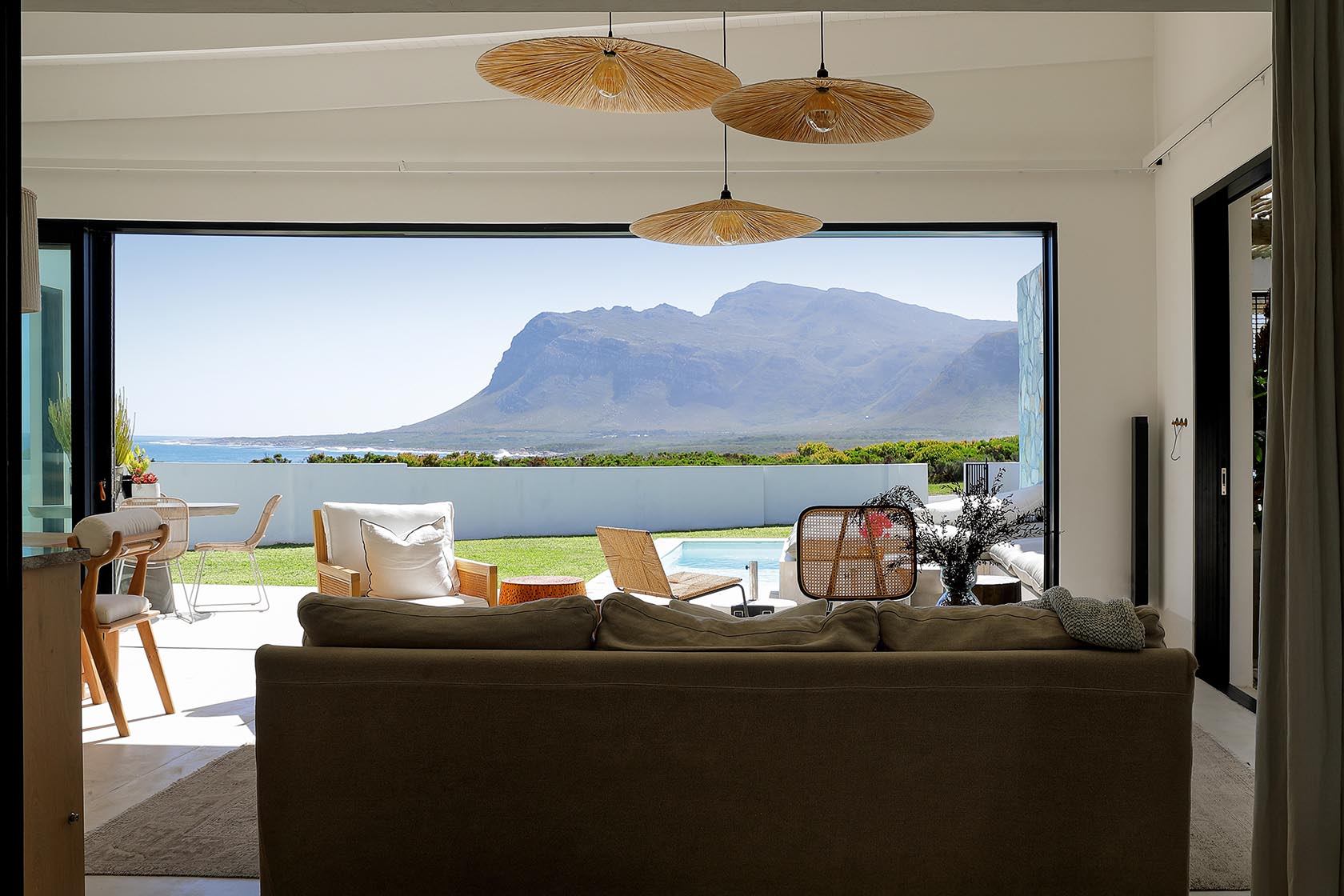 Perfect Hideaways open-plan lounge framed by panoramic mountain and sea views through expansive sliding doors, Soudt, Kleinmond