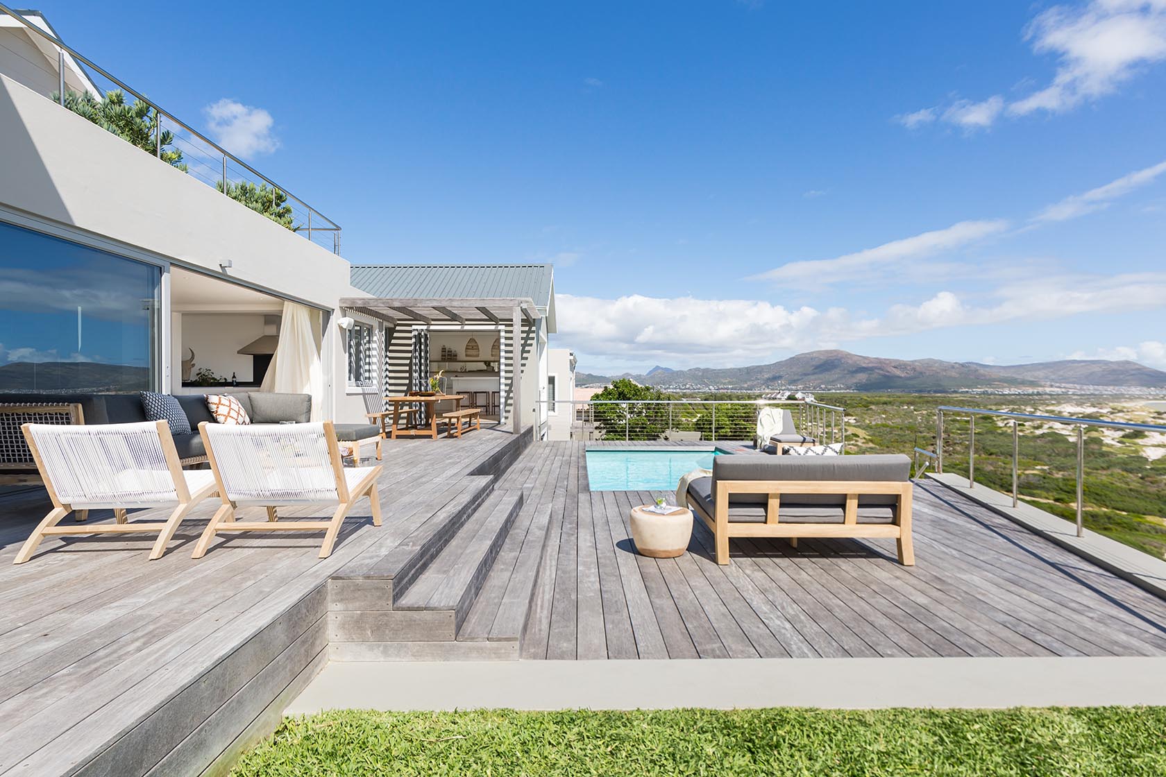 Perfect Hideaways - Expansive coastal deck with outdoor seating, swimming pool and panoramic views across Noordhoek wetlands and surrounding mountains Noordhoek Seashore_Noordhoek_Southern Peninsula_Cape Town_Western Cape_South Africa