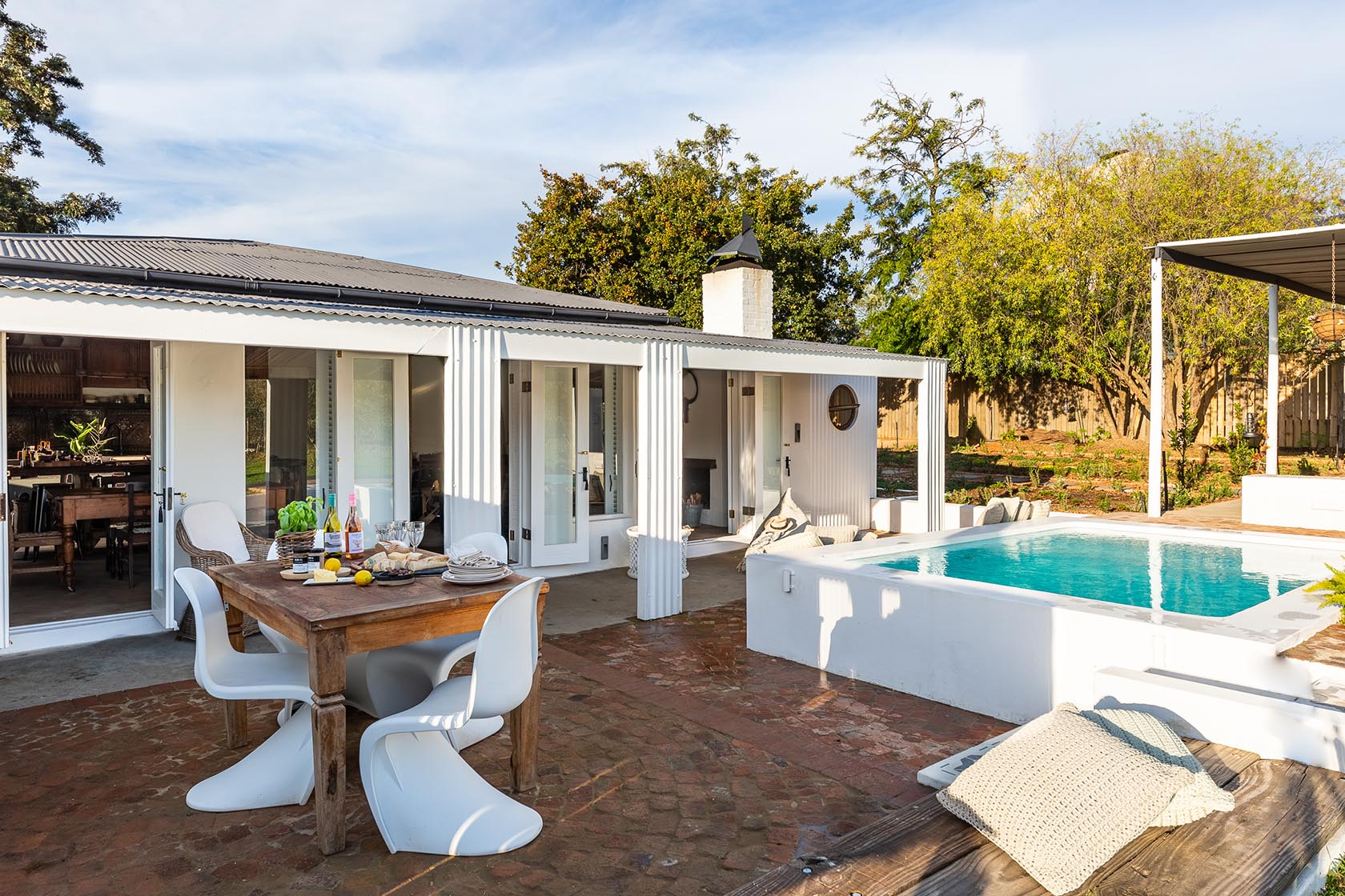 Perfect Hideaways-Outdoor patio with a wooden dining table set for a meal, adjacent to the pool and shaded veranda, surrounded by trees and garden views Valley Cottage, Riebeek Casteel, Western Cape, South Africa