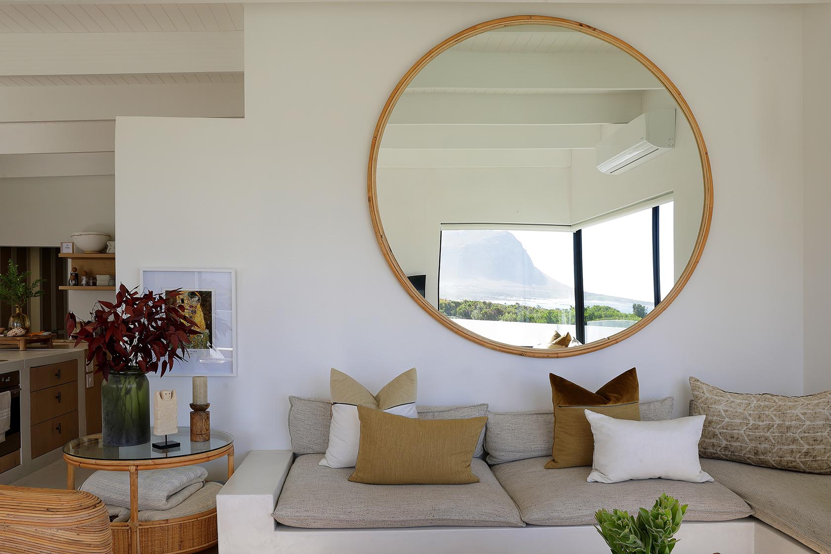 Perfect Hideaways stylish lounge with oversized round mirror reflecting mountain views, neutral cushions and warm wooden textures, Soudt, Kleinmond