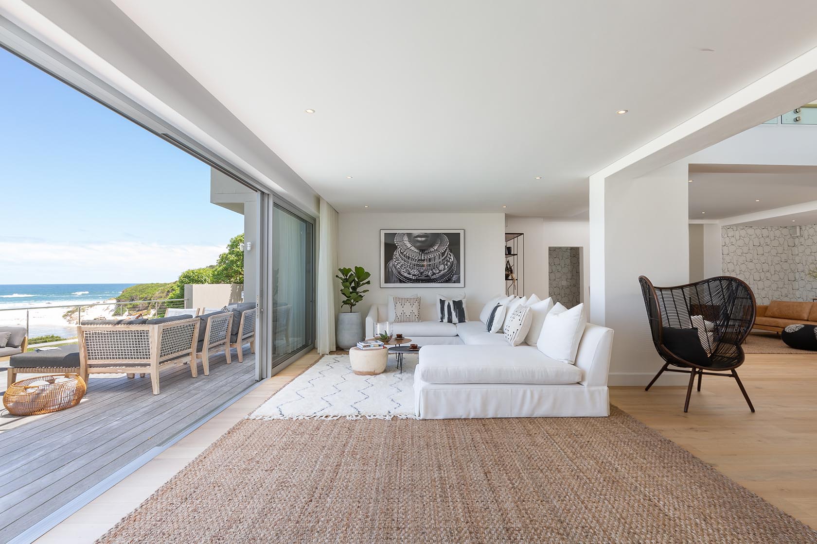 Perfect Hideaways - Light-filled open-plan lounge with white sofas, natural textures and direct access to an ocean-facing deck overlooking Noordhoek beach Noordhoek Seashore_Noordhoek_Southern Peninsula_Cape Town_Western Cape_South Africa