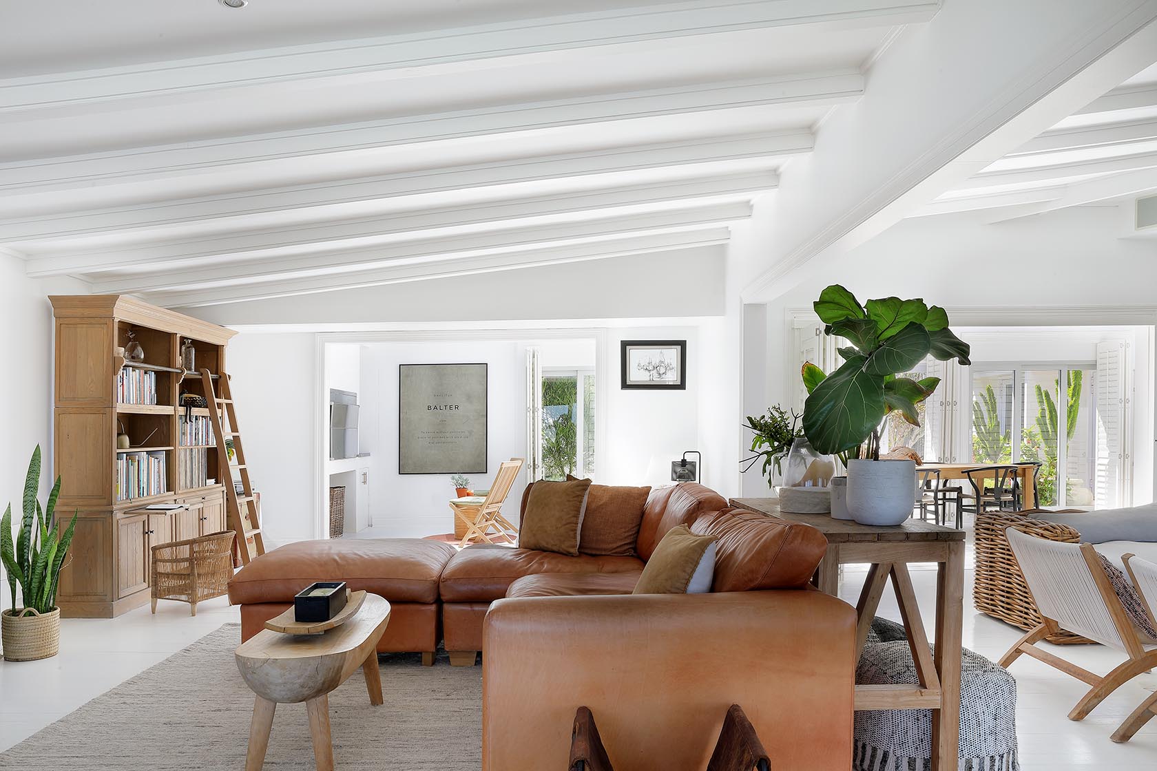 Perfect Hideaways - Relaxed living room with leather sofa, timber furniture and indoor plants, opening toward the dining area and garden-facing entertaining spaces Cape Cottage_Yzerfontein_West Coast_Western Cape_South Africa