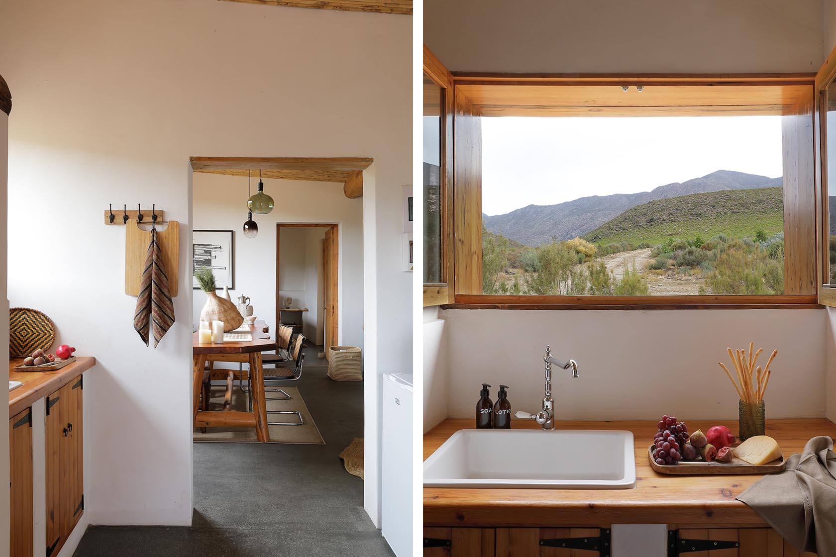 Perfect Hideaways – A view from the kitchen into the dining room, showing wooden cabinetry, chopping boards on hooks, and a large picture window framing the Karoo landscape. A second image shows the kitchen sink beneath a wide open window, displaying rolling green hills outside. Sheperd's Cottage, Prince Albert