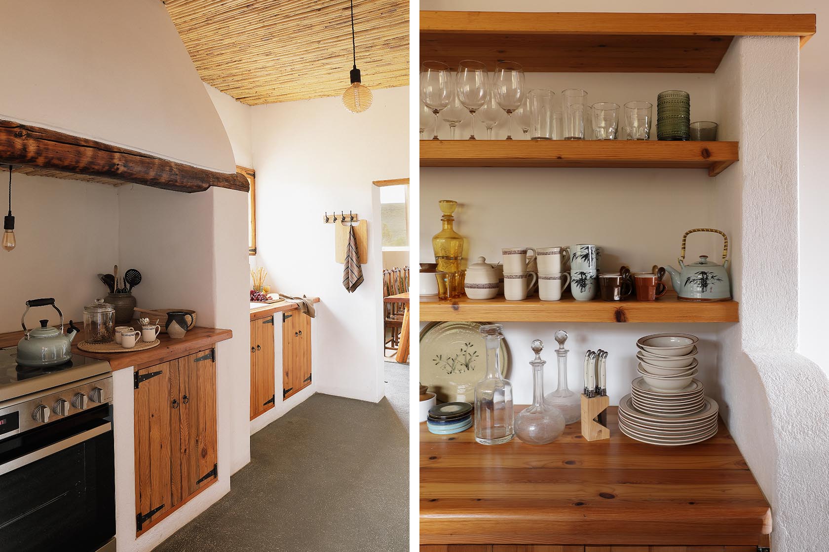 Perfect Hideaways – A rustic kitchen with wooden cupboards and open shelves stacked with crockery, glassware, and ceramics. Warm light highlights natural textures, from the bamboo ceiling to the timber countertops. Sheperd's Cottage, Prince Albert