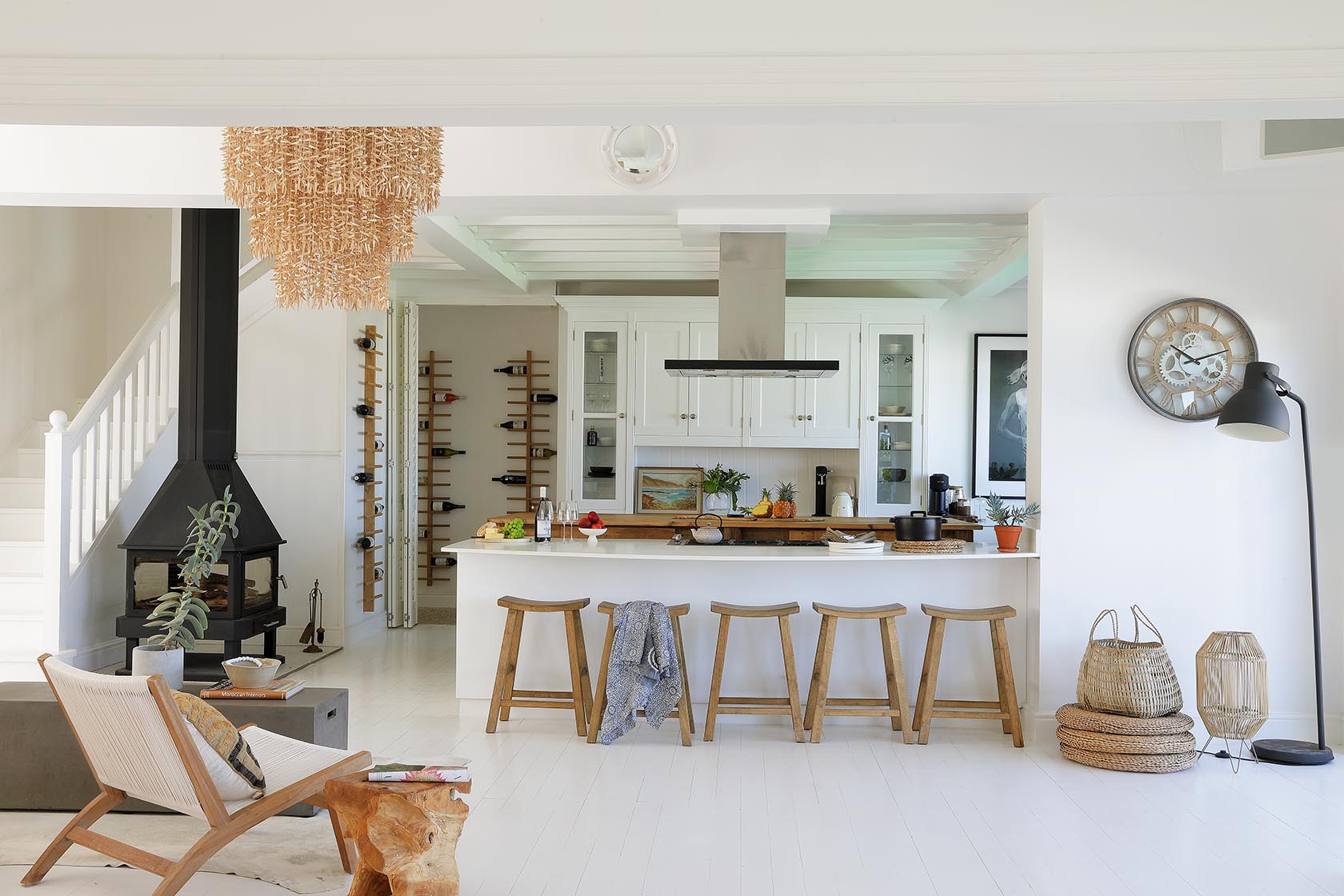 Perfect Hideaways - Contemporary kitchen with white cabinetry, wooden bar stools and central island, complemented by a fireplace and curated décor in an airy open-plan layout Cape Cottage_Yzerfontein_West Coast_Western Cape_South Africa