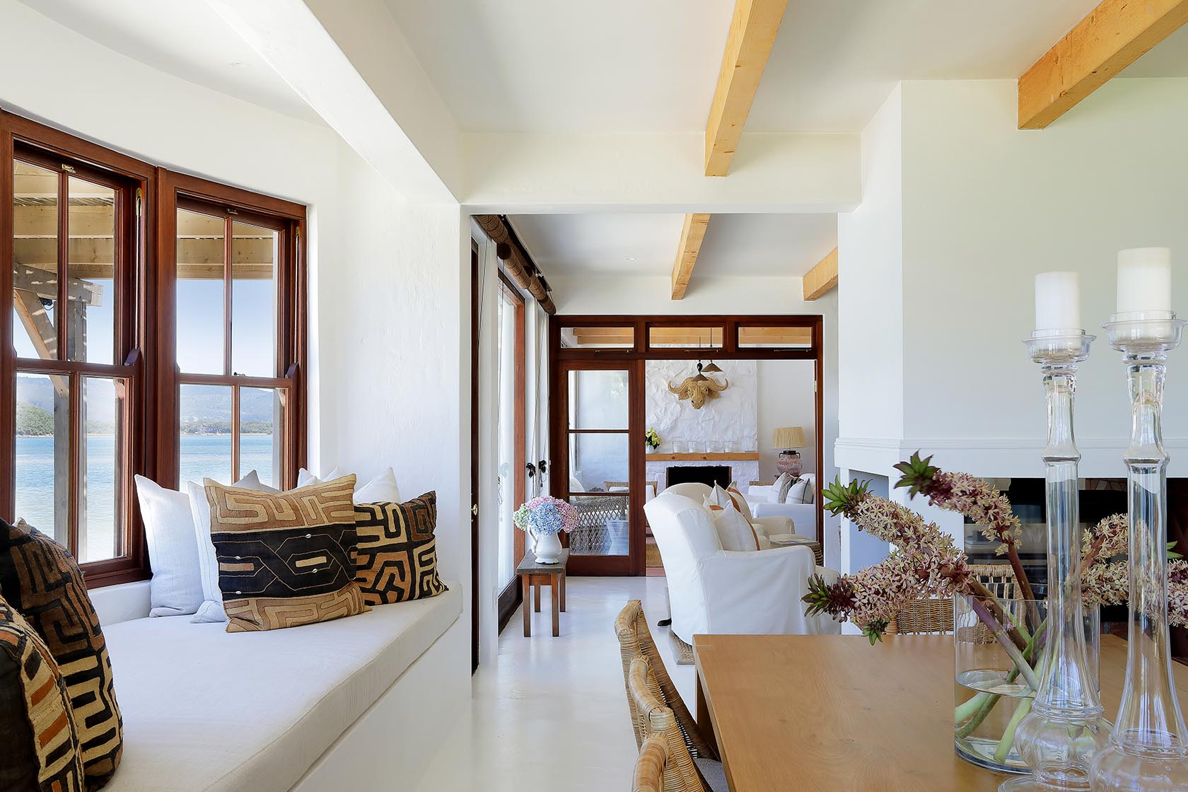 Perfect Hideaways: Window seat with patterned cushions beside the dining area, framing serene views of the lagoon, Knysna, Tides Reach