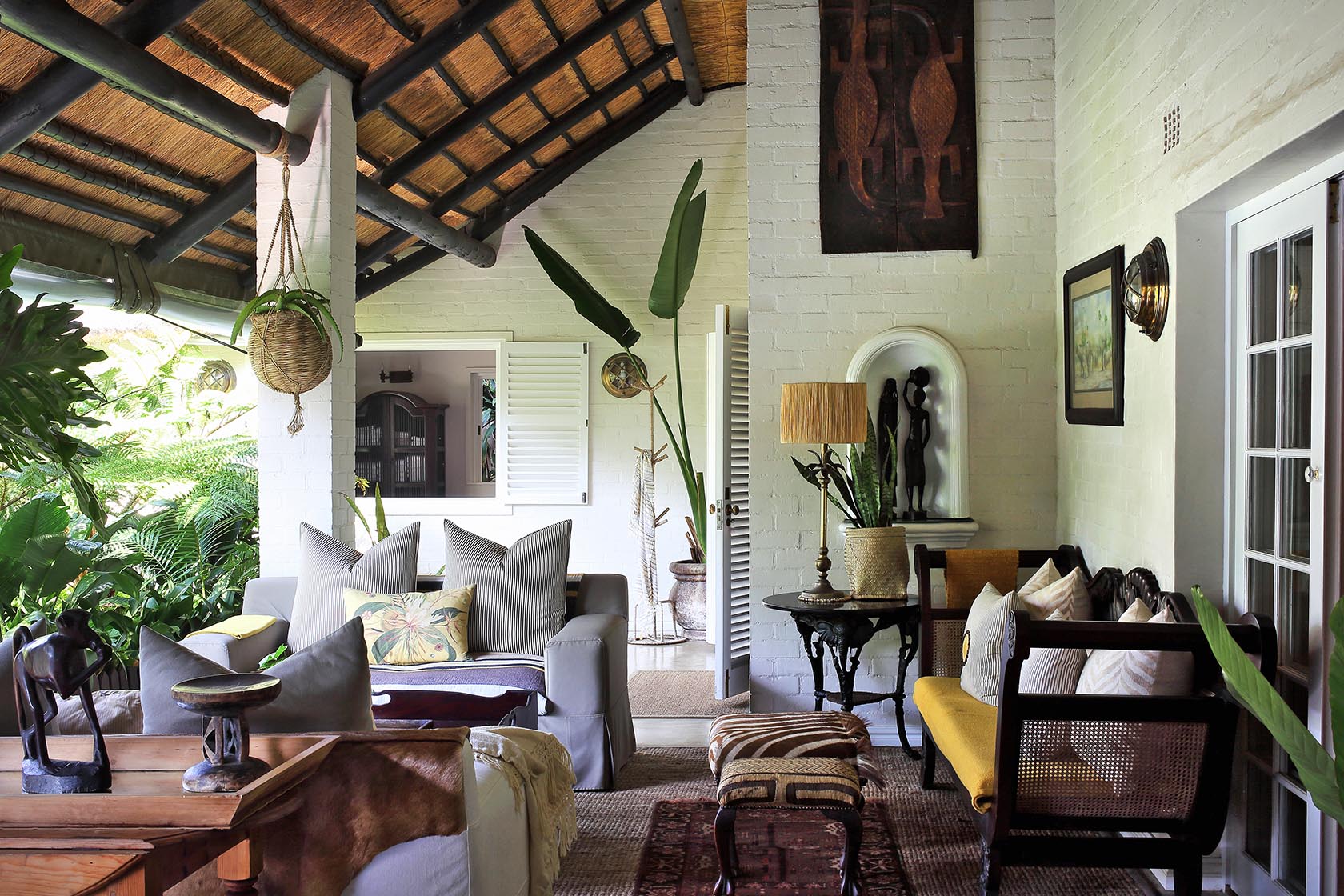 Perfect Hideaways- A covered veranda lounge with comfortable seating, natural textiles, hanging planters, and views into a leafy garden cowrie Cottage, Dolphin Coast, Kwazulu- Natal, South Africa