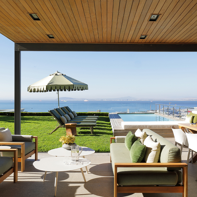 Perfect Hideaways contemporary outdoor lounge and dining terrace with ocean views, sun loungers, manicured lawn and infinity pool overlooking the Atlantic Ocean, Hawk's Eye, Green Point
