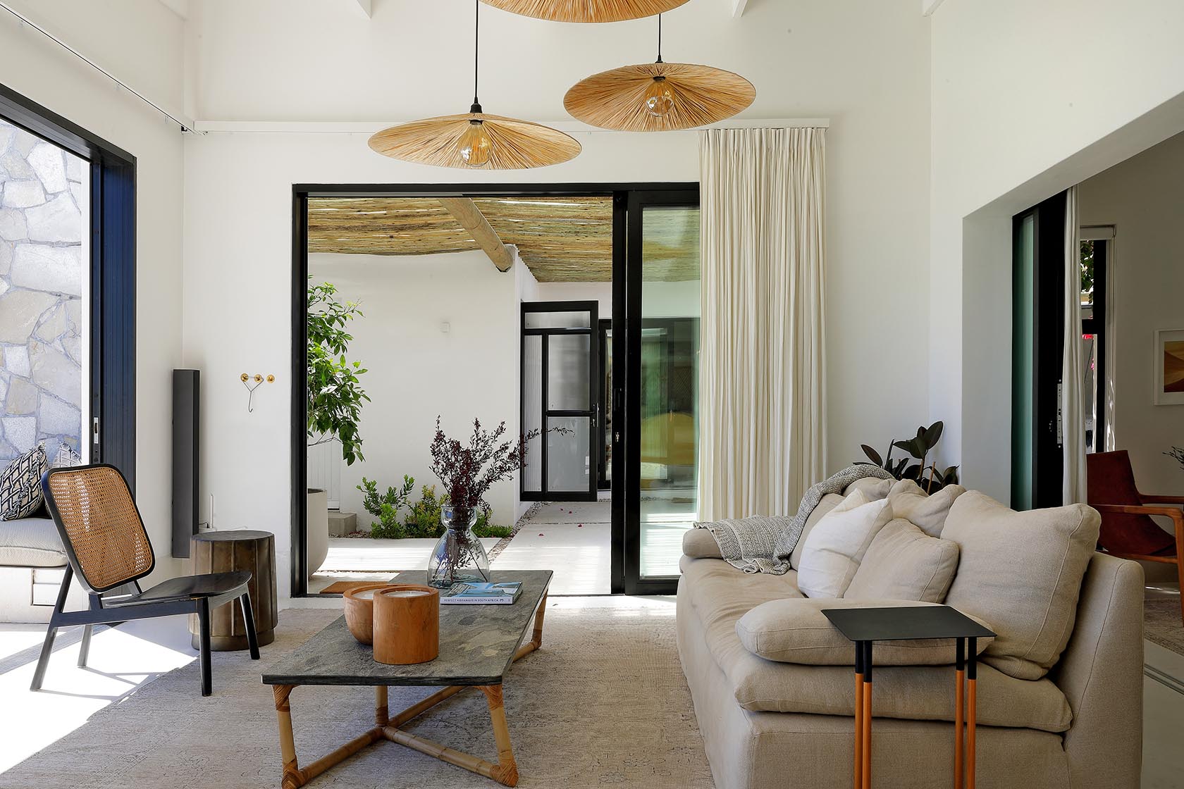 Perfect Hideaways elegant lounge with woven pendant lights, soft neutral furnishings and seamless flow to a private courtyard, Soudt, Kleinmond