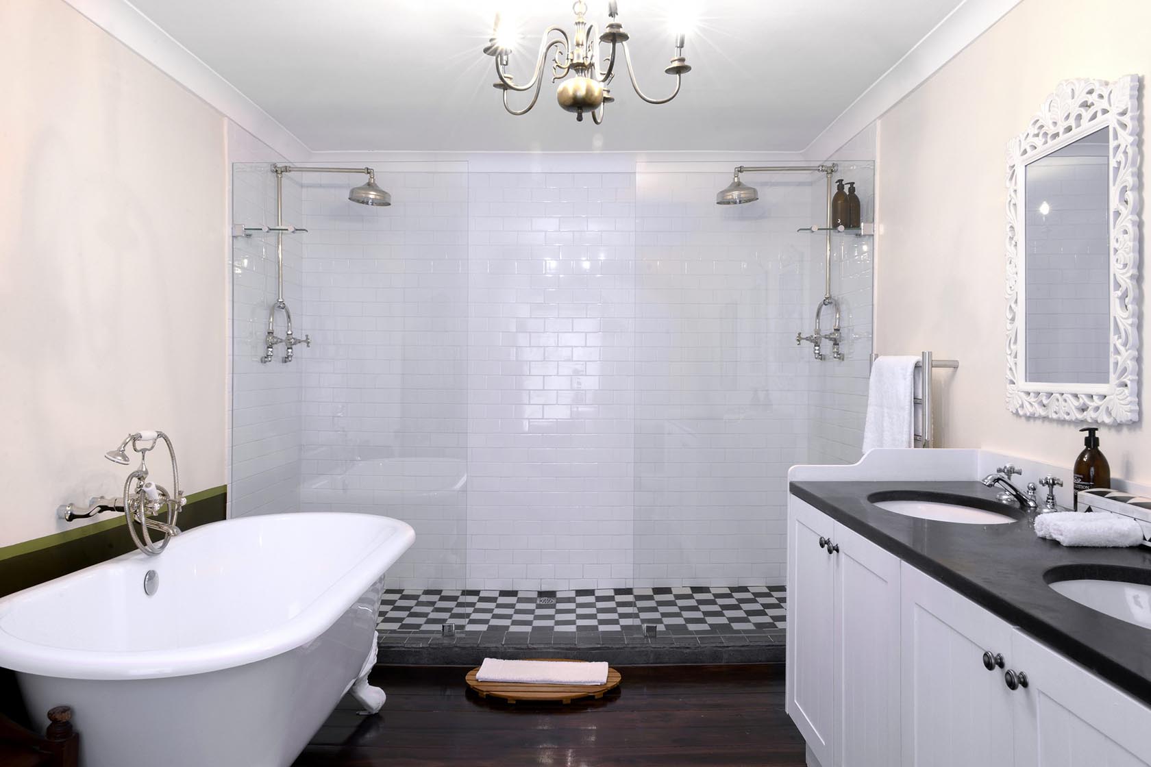 Perfect Hideaways – A spacious bathroom featuring a freestanding clawfoot tub, double basins, a large walk-in shower with twin showerheads, and soft lighting for a serene, luxurious feel – Cottage 1685, Franschhoek, Western Cape, South Africa