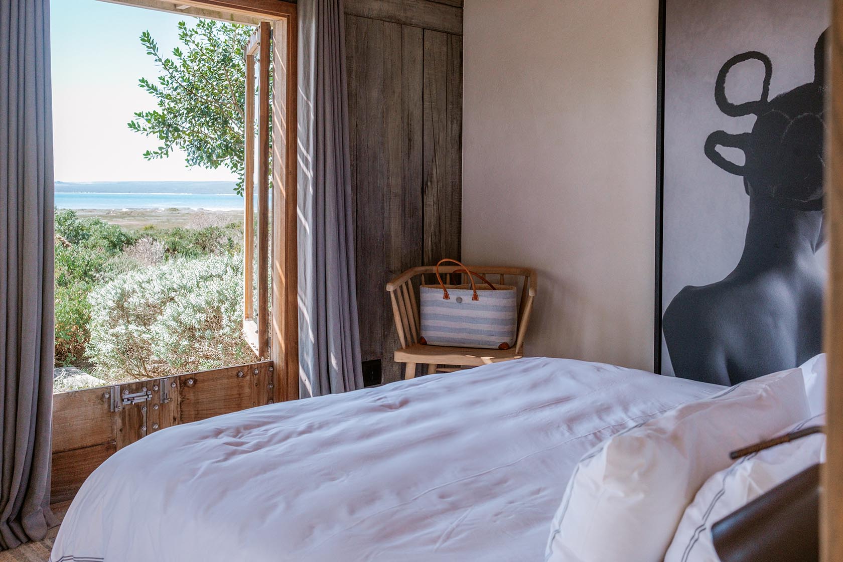Perfect Hideaways- Serene bedroom with crisp white bedding, timber walls, a chair with a woven bag and an open window framing lagoon and fynbos views, Yellowwood Cottage, Churchhaven, Western Cape, South Africa