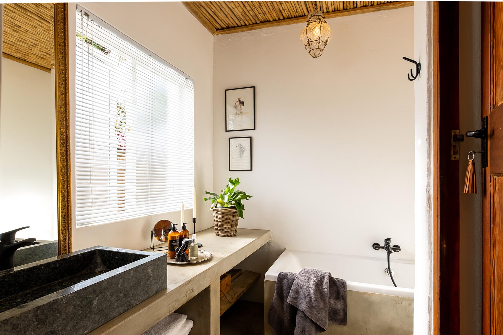 Perfect Hideaways-Bathroom interior with a concrete vanity, stone basin, freestanding bathtub, soft towels, and warm natural light beneath a reed ceiling Valley Cottage, Riebeek Casteel, Western Cape, South Africa