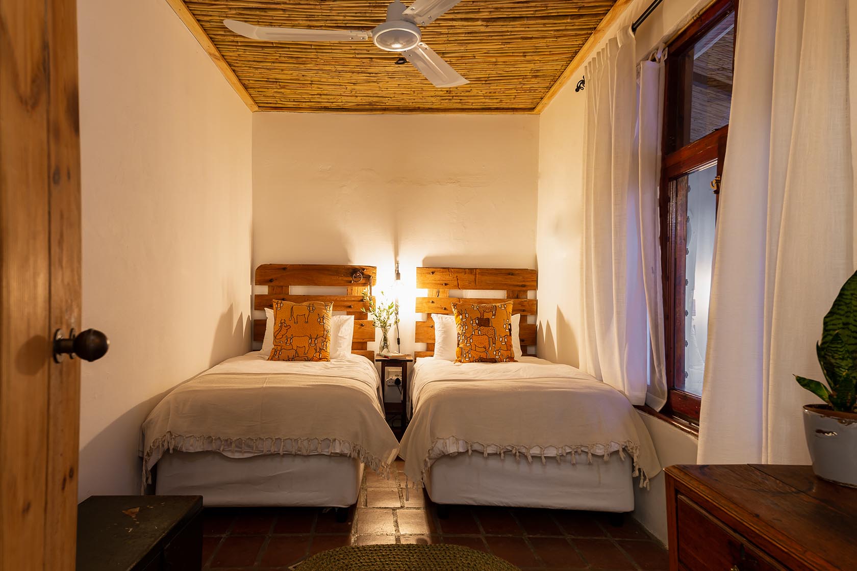 Perfect Hideaways-Cozy twin bedroom with two single beds dressed in neutral linen, wooden headboards, patterned scatter cushions, and a reed ceiling with ceiling fan, creating a warm and restful atmosphere Valley Cottage, Riebeek Casteel, Western Cape, South Africa