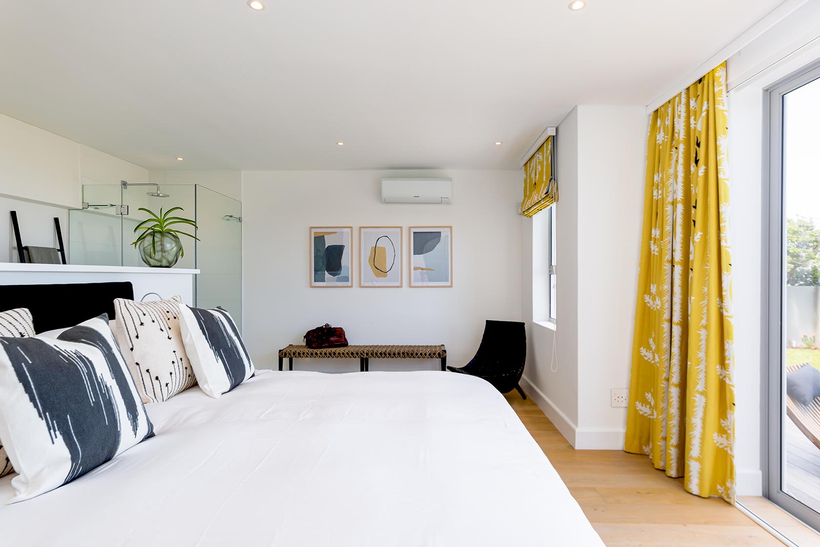 Perfect Hideaways - Light-filled bedroom with plush white bedding, patterned cushions and sliding doors leading to a sea-facing terrace Noordhoek Seashore_Noordhoek_Southern Peninsula_Cape Town_Western Cape_South Africa