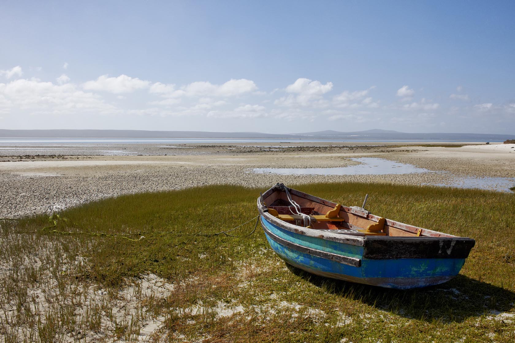 Perfect Hideaways colourful boat resting beside the lagoon, Seagull Cottage, Churchhaven