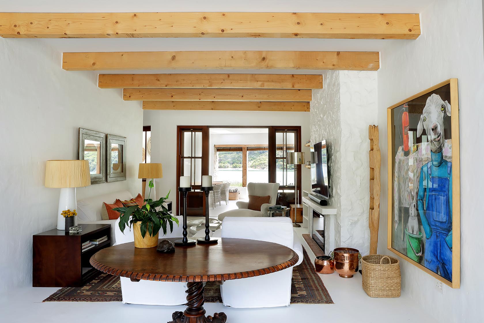 Perfect Hideaways: Entrance hall with hat rack leading to a light lounge framed by timber doors and lagoon views beyond, Knysna, Tides Reach