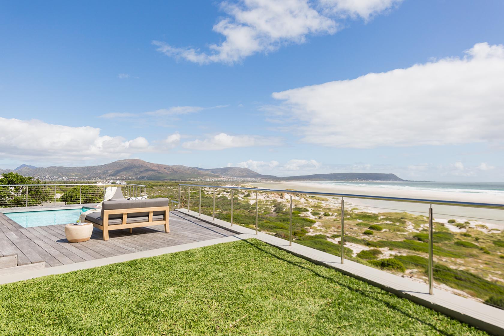 Perfect Hideaways - Elevated outdoor deck with sun loungers, swimming pool and sweeping panoramic views across Noordhoek beach, dunes and surrounding mountains Noordhoek Seashore_Noordhoek_Southern Peninsula_Cape Town_Western Cape_South Africa