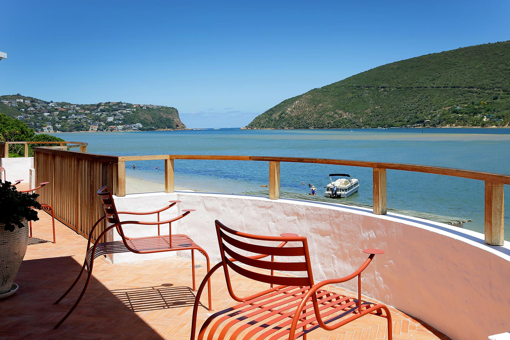 Perfect Hideaways: Quiet work nook with sculptural timber desk, woven chair and vintage cabinet beside sheer curtains, Knysna, Tides Reach
