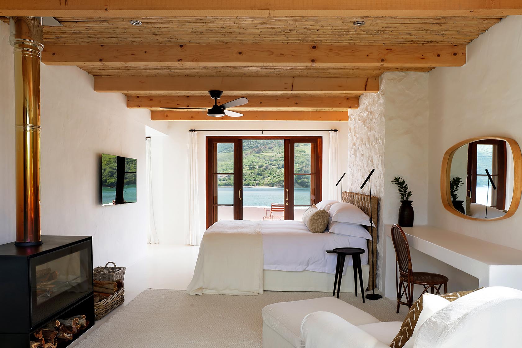 Perfect Hideaways: Minimalist bathroom with freestanding tub, walk‑in shower and matt‑black fittings beneath a reed‑clad ceiling, Knysna, Tides Reach