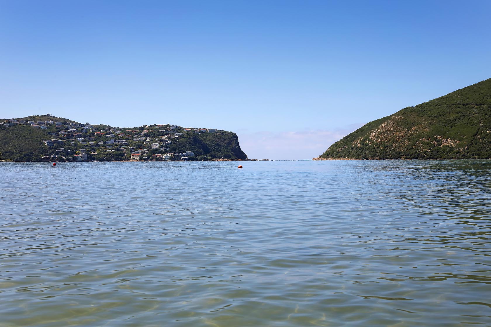 Perfect Hideaways: Wide view across the calm lagoon towards the Knysna Heads between forested cliffs, Knysna, Tides Reach
