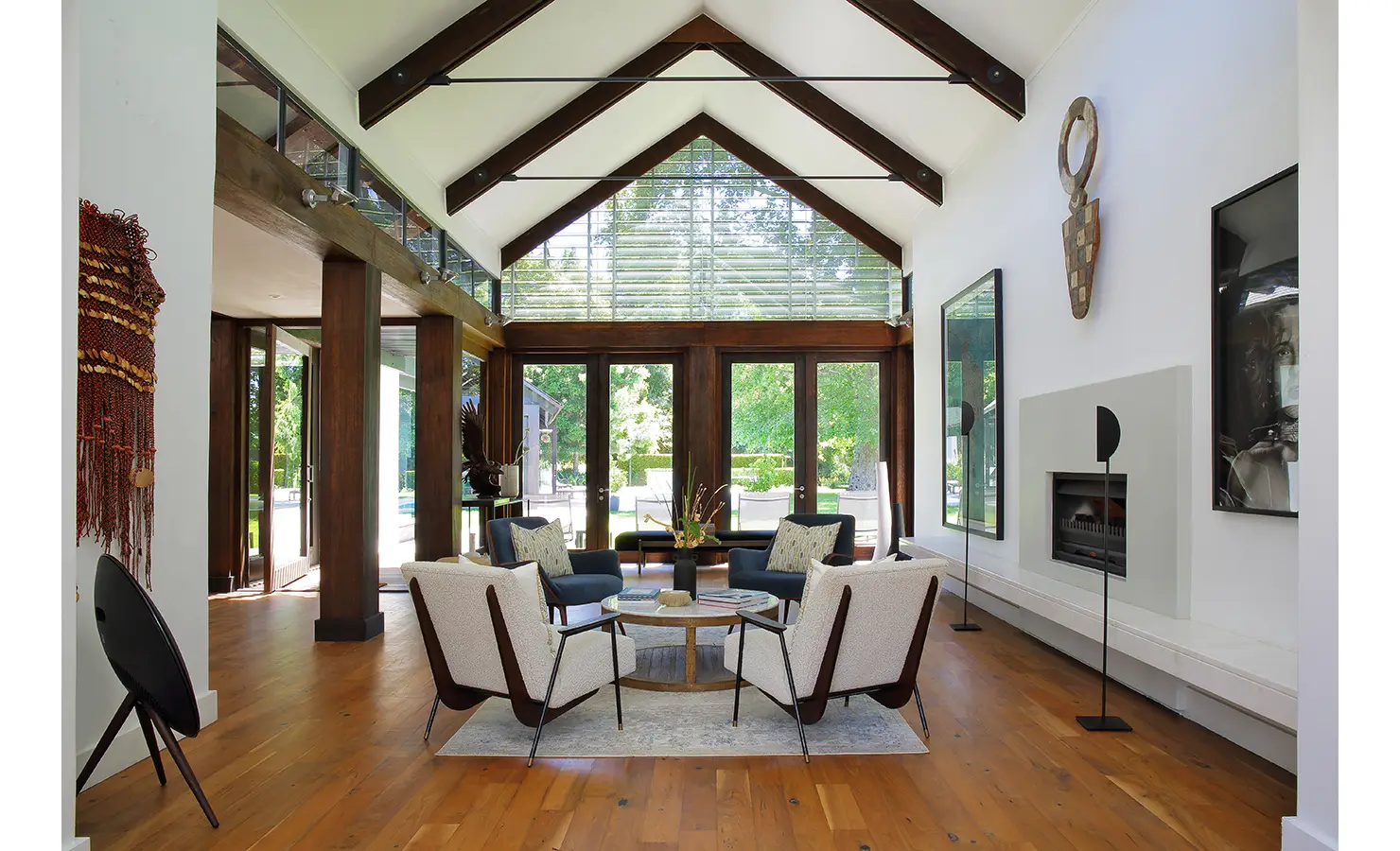 Perfect Hideaways double-volume living space with exposed timber beams, glass doors opening to the garden, contemporary seating area, and warm wooden floors, Tres Ossos, Constantia