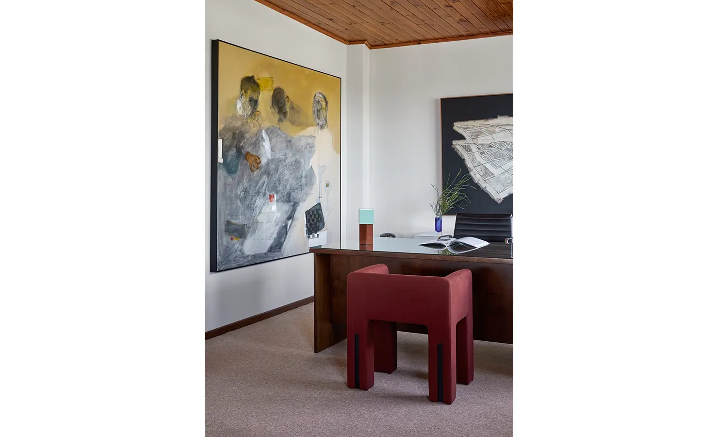 Perfect Hideaways a sophisticated study area with a deep wood desk, bold abstract artworks, and a sculptural red stool, blending modern design elements with soft natural light Camps Bay, The Liminal