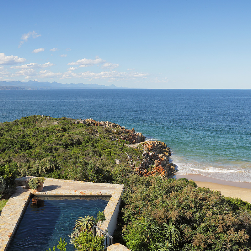 Perfect Hideaways secluded oceanfront pool terrace overlooking a pristine sandy beach and rugged coastline with panoramic sea and mountain views, Djinn Palace, Plettenberg Bay