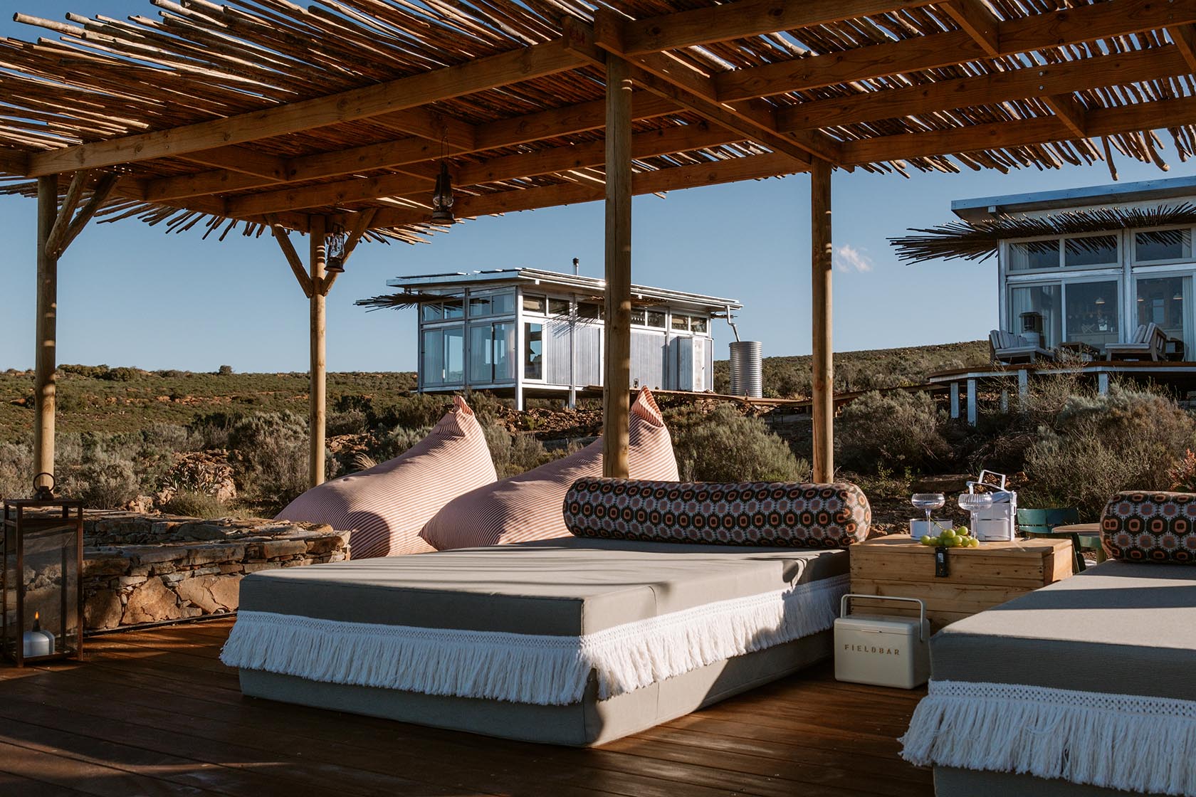 Perfect Hideaways outdoor lounge with daybeds and beanbags beneath a rustic pergola, Jackals Rest, Montagu.