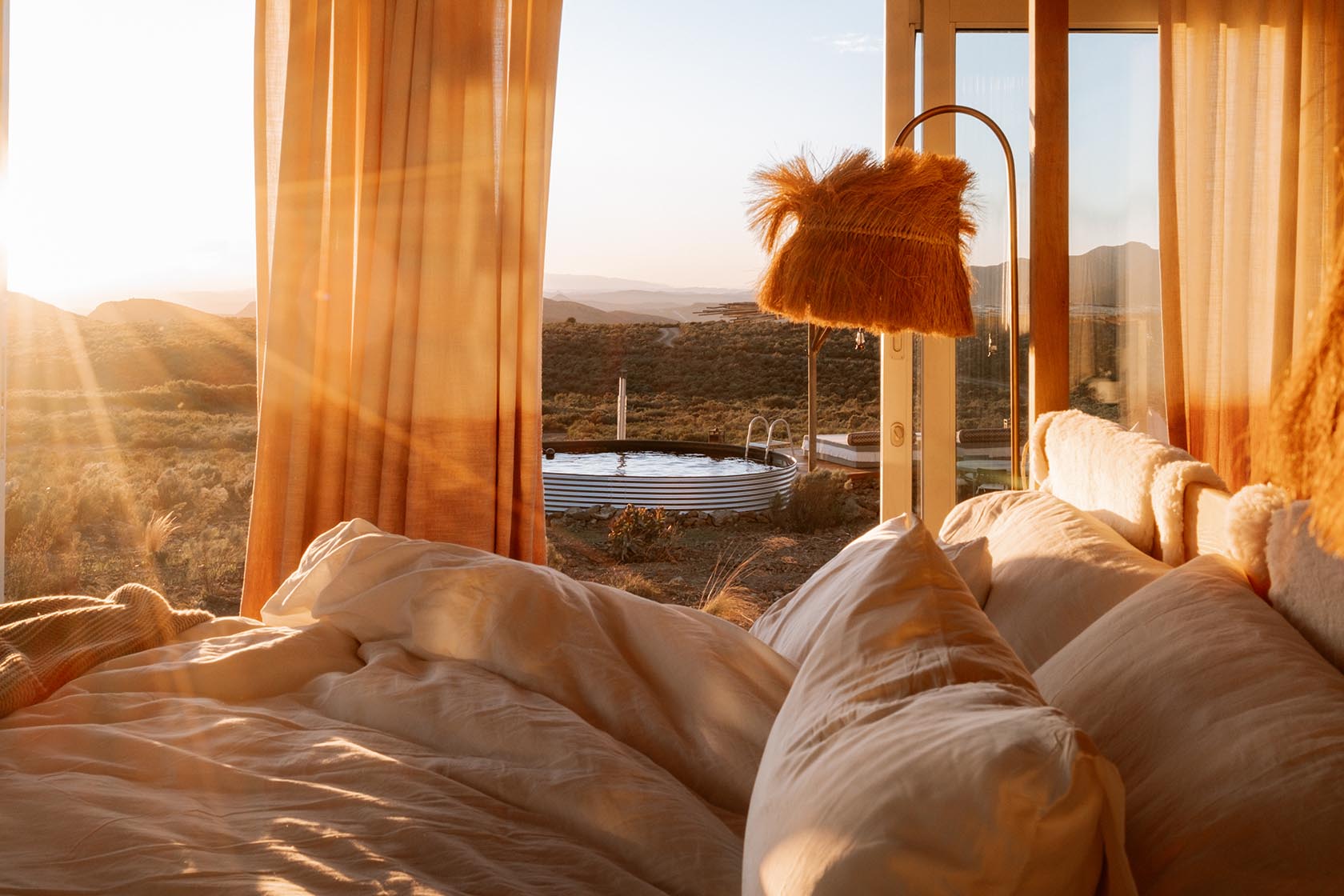 Perfect Hideaways luxurious bed with panoramic sunrise views overlooking the outdoor plunge pool, Jackals Rest, Montagu.