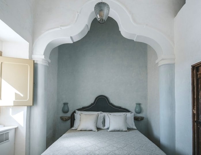 A calming bedroom retreat at Villa Tafuri, which is surrounded by four hectares of flourishing farmland